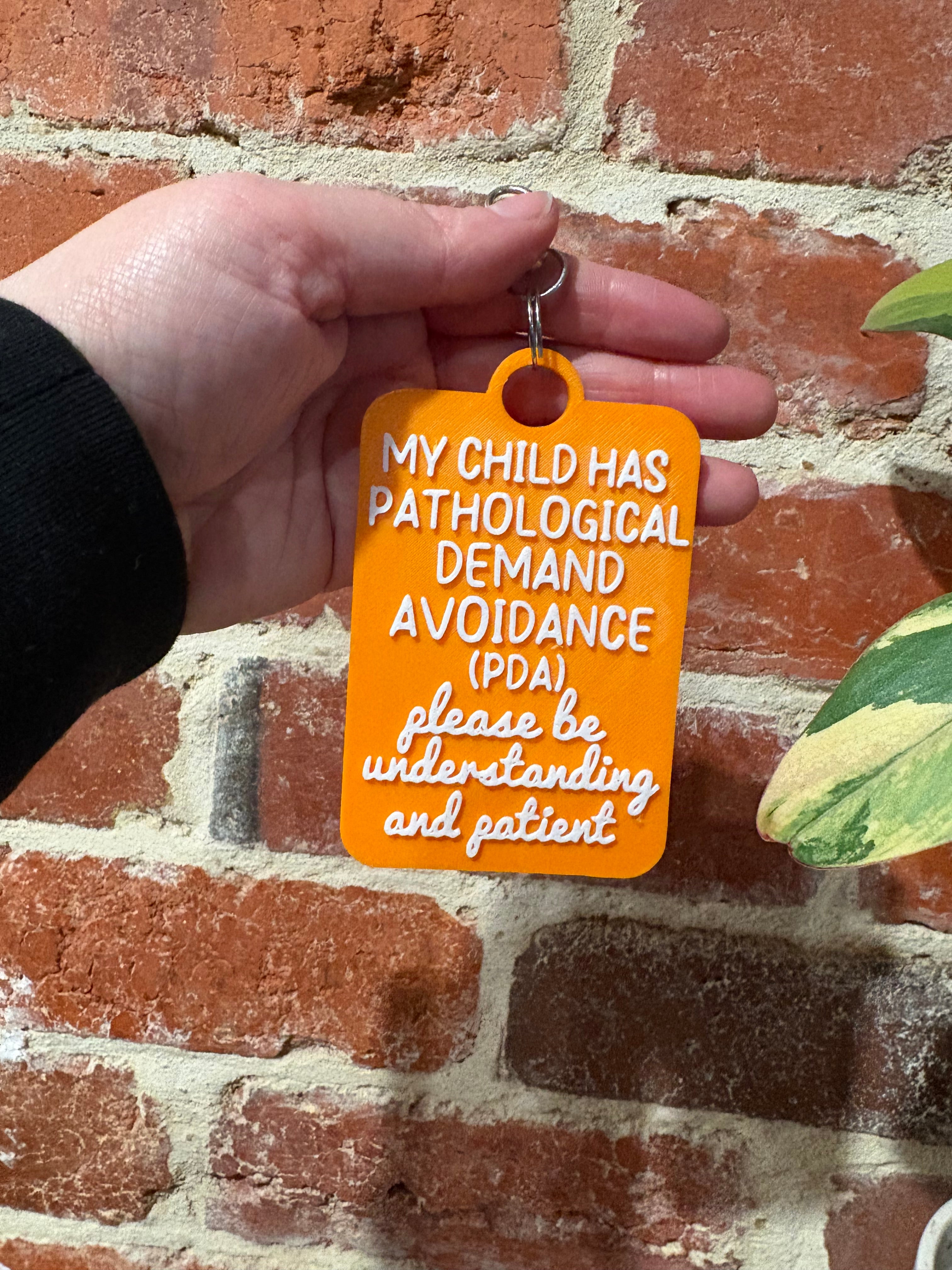 'My Child Has Pathological Demand Avoidance PDA' Talkies Awareness Tag - Coloured Background with White Text