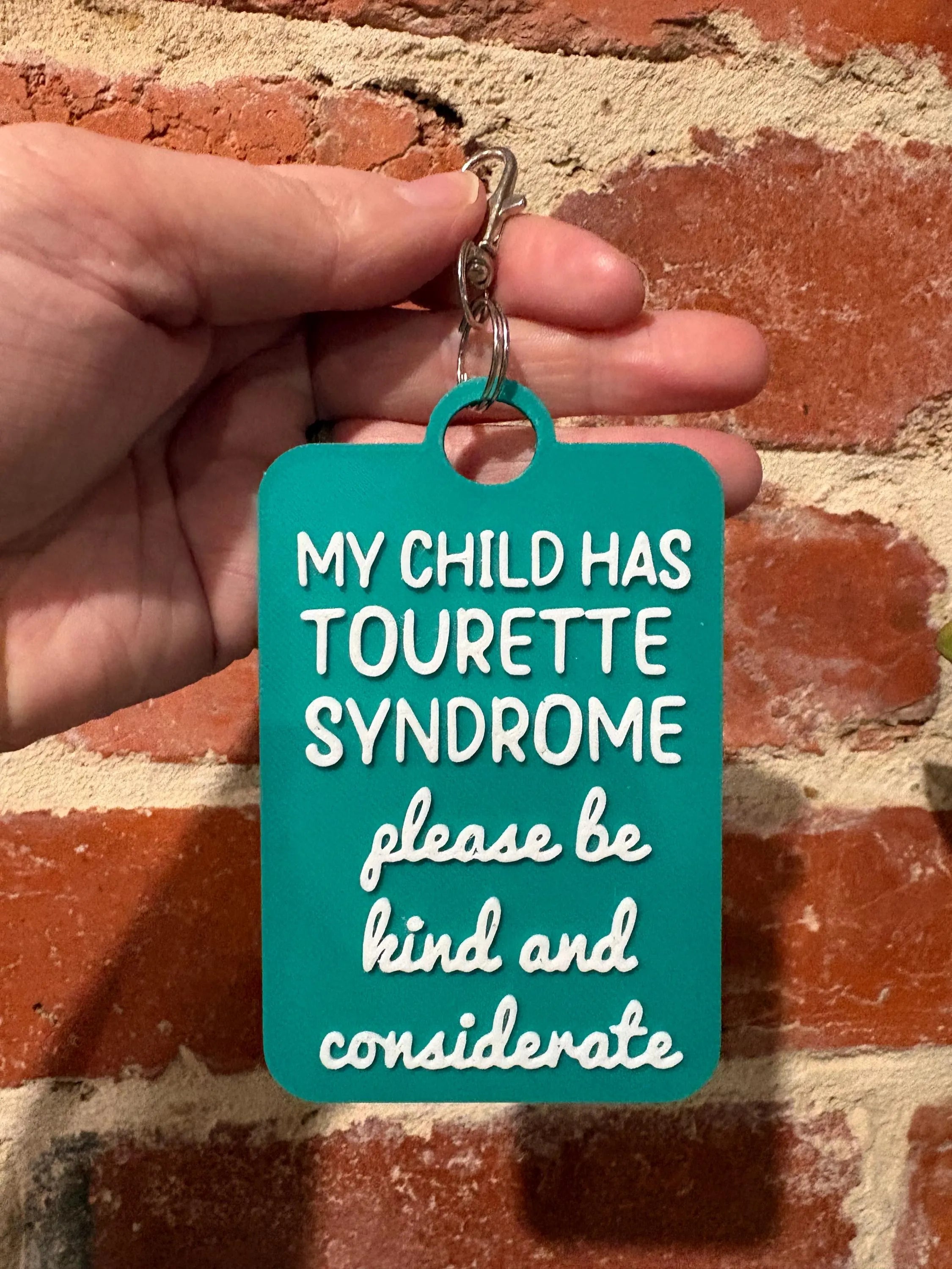 'My Child Has Tourette Syndrome' Talkies Awareness Tag - Coloured Background with White Text